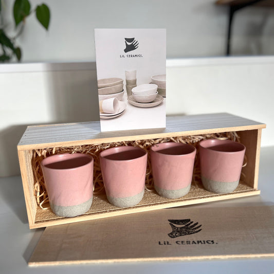 a set of 4 pink ceramic Lil Ceramics tumblers in a wooden box with Lil Ceramics stamped on the box