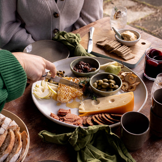 Cheese platter featuring Lil Ceramics XL Platter, olive bowl, side plate, and tumbler; all handmade in Auckland, New Zealand
