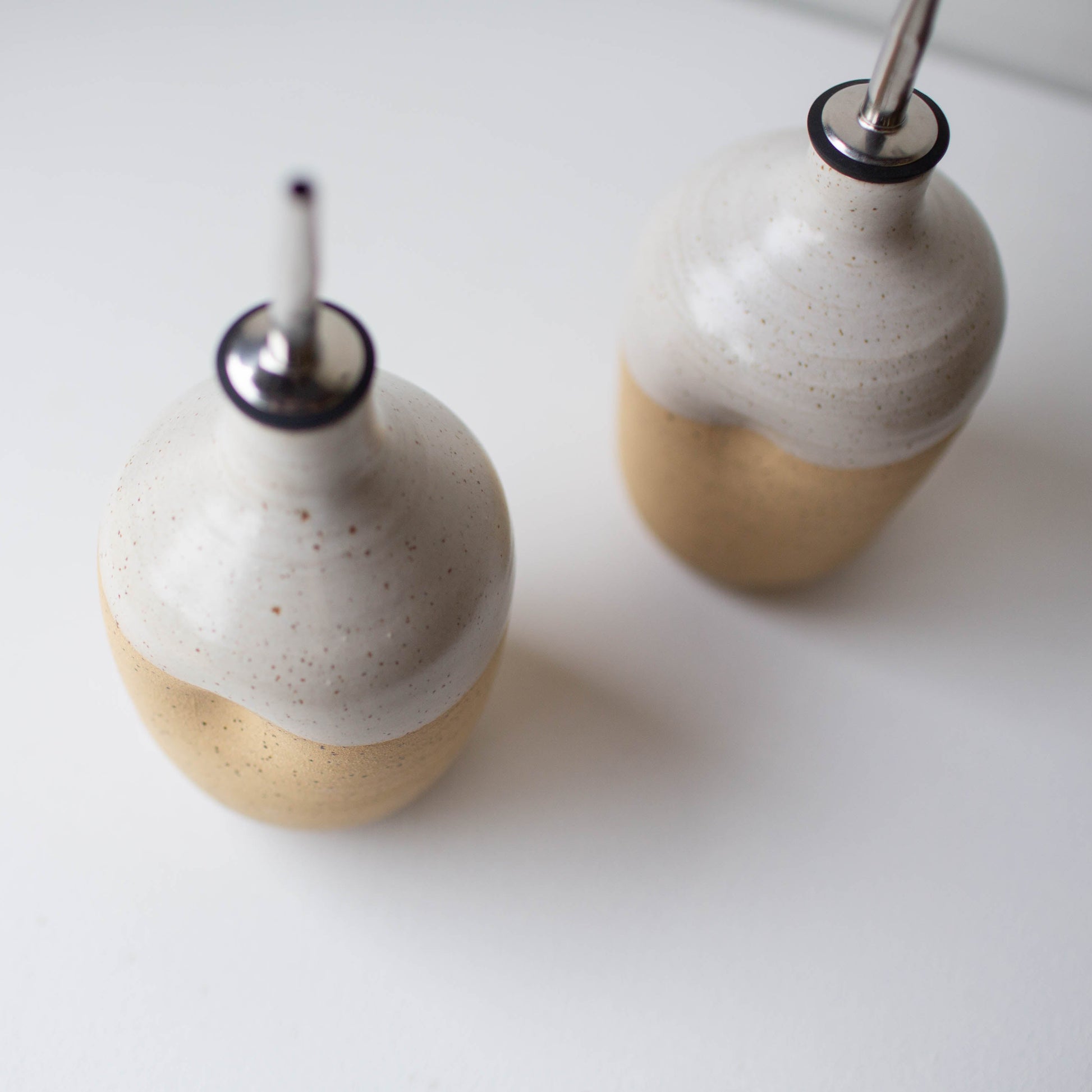 Lil Ceramics two handmade ceramic oil pourers on a white surface, made in Auckland New Zealand