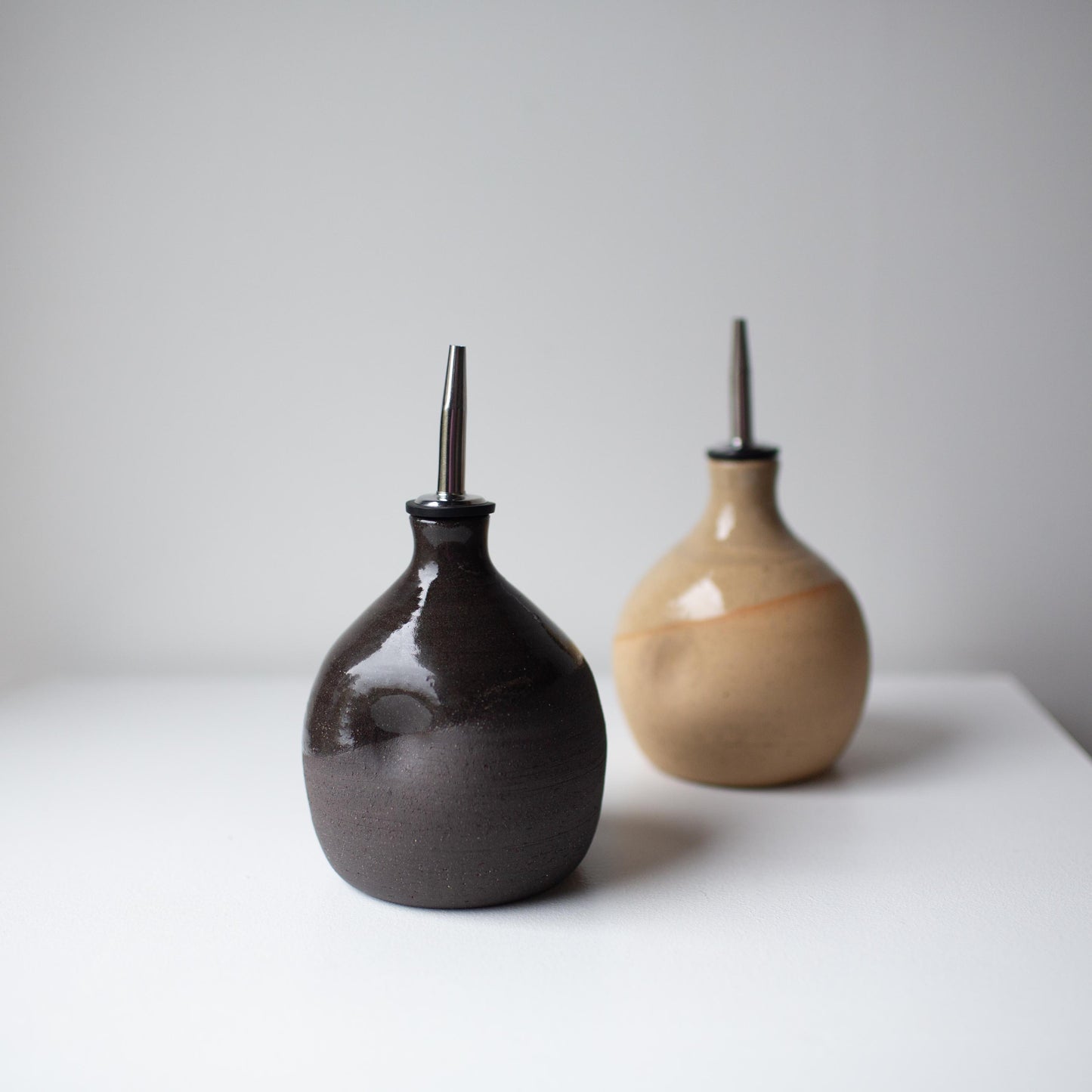 Lil Ceramics handmade oil pourers in charcoal and speckled tan