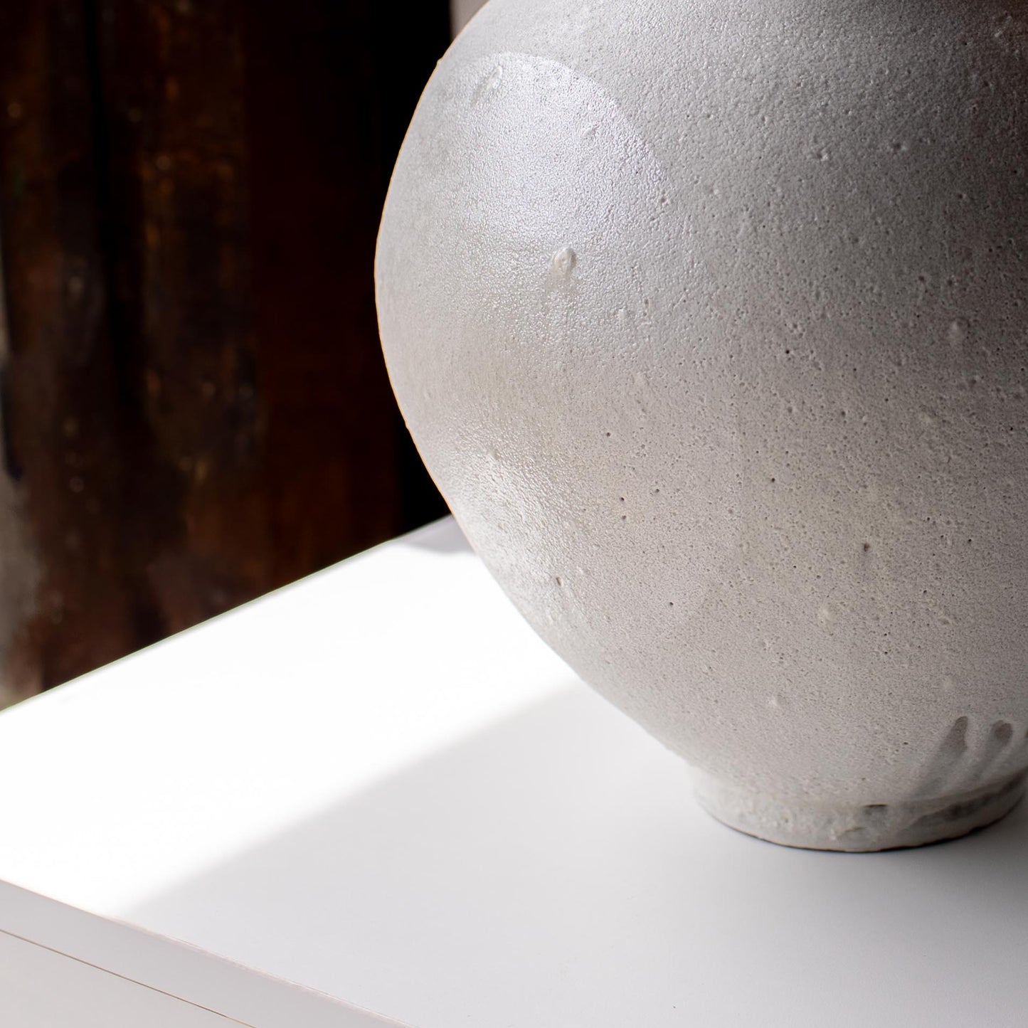 Close view of white ceramic vase with pearl lustre